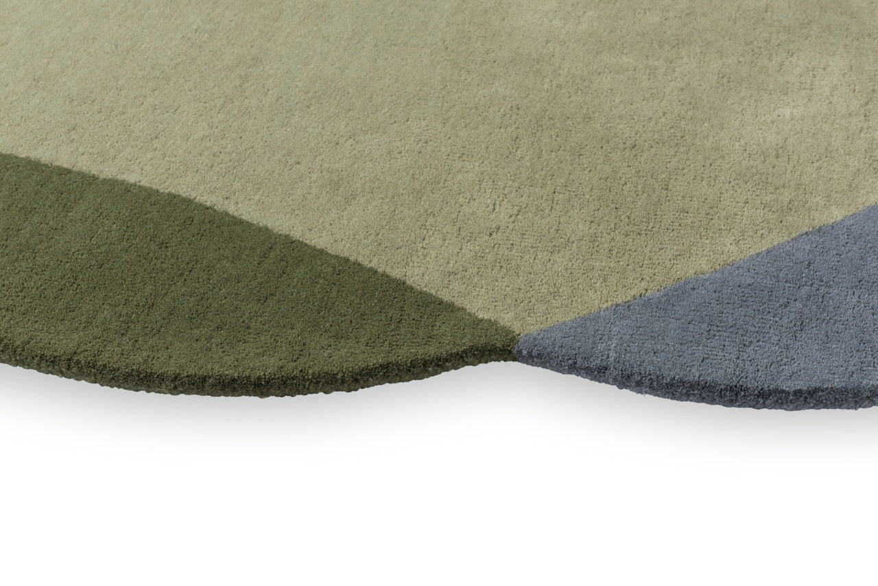 Close-up of hand-tufted wool texture in grey and green tones