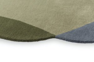 Close-up of hand-tufted wool texture in grey and green tones