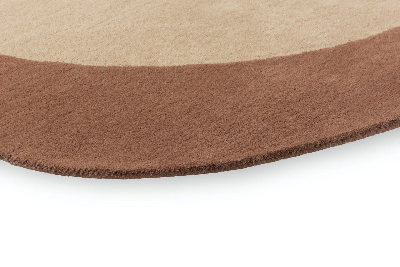Close-up of hand-tufted wool texture in caramel tones

