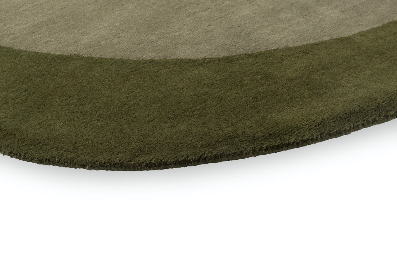 Close-up of moss green wool texture with high-relief sculptural carving