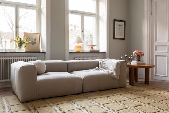 Layered Swedish Homage Lilly Mustard yellow rug in modern living room - geometric wool area rug