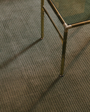 Layered Drift Wool Olive olive green wool rug, close up in an interior