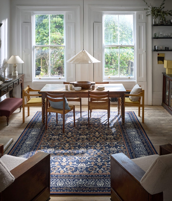 Morris & Co Borage Blue rug in indigo, ivory and caramel, shown in an interior