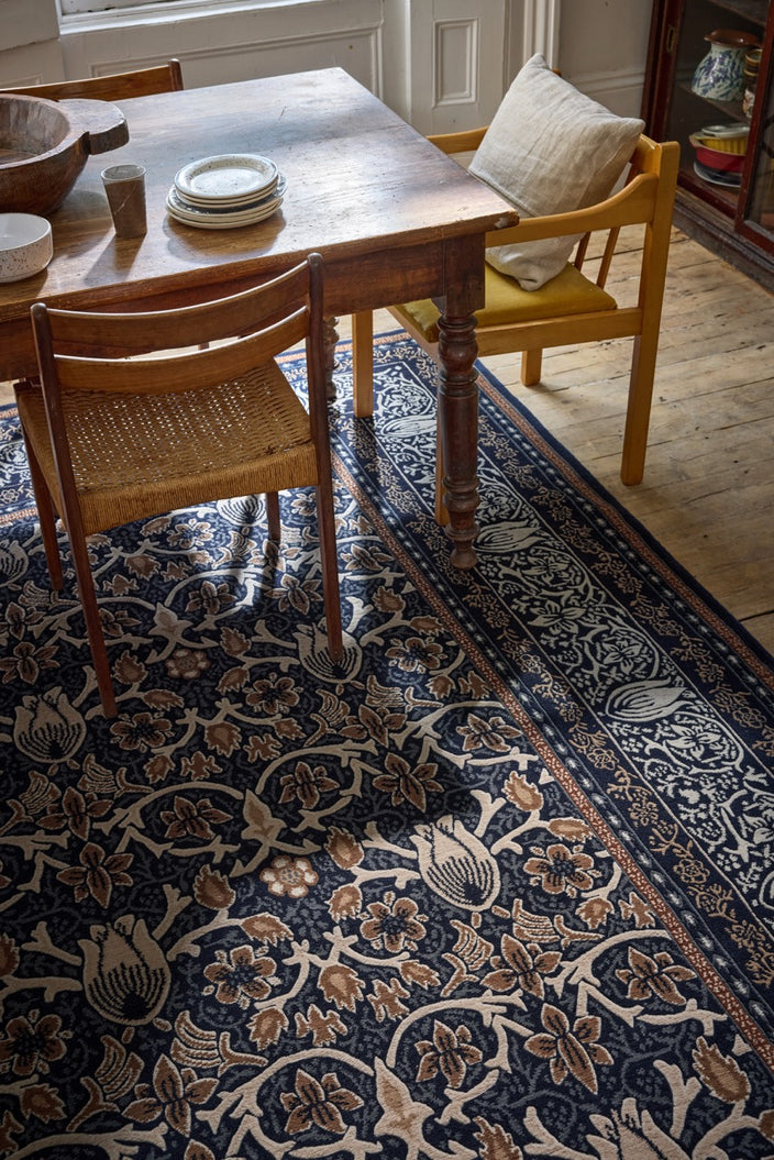 Morris & Co Borage Blue rug in indigo, ivory and caramel, shown in an interior, second view