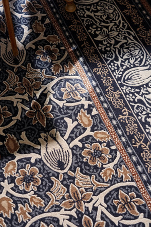 Morris & Co Borage Blue rug in indigo, ivory and caramel, shown in an interior, third view