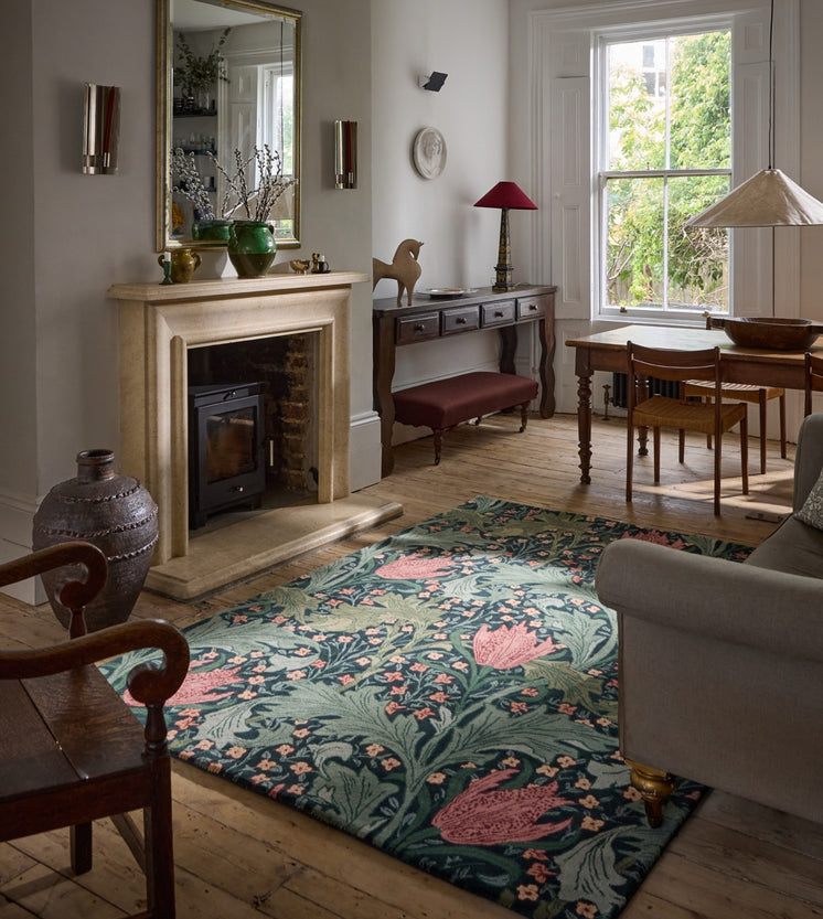 Morris & Co Lent Lily Indigo Madder rug in indigo with madder red tulips and sage leaves, shown in an interior