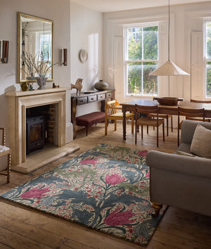 Morris & Co Lent Lily Plum Bayleaf rug in cream with plum tulips and bay green leaves, shown in an interior