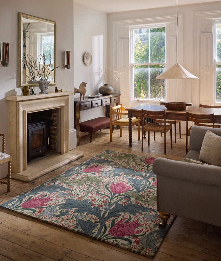 Morris & Co Lent Lily Plum Bayleaf rug in cream with plum tulips and bay green leaves, shown in an interior