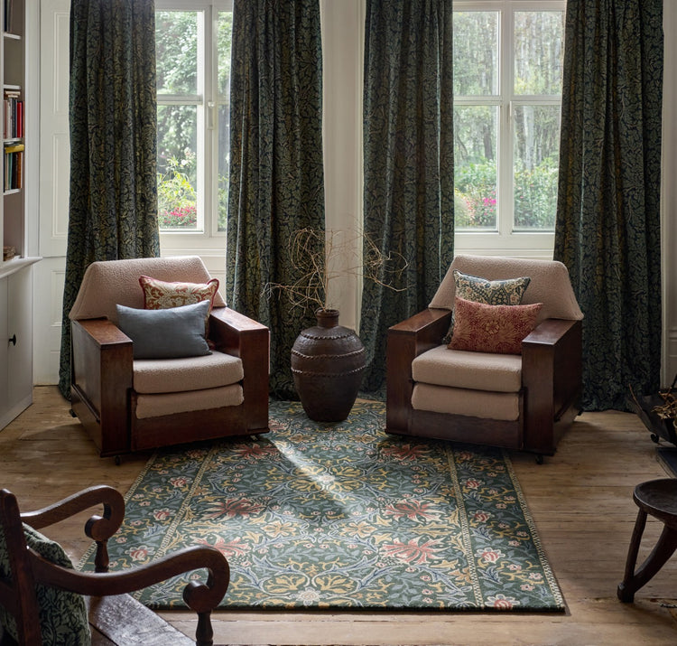 Morris & Co Walthamstow Forest Teal rug in forest green, teal and old gold, shown in an interior