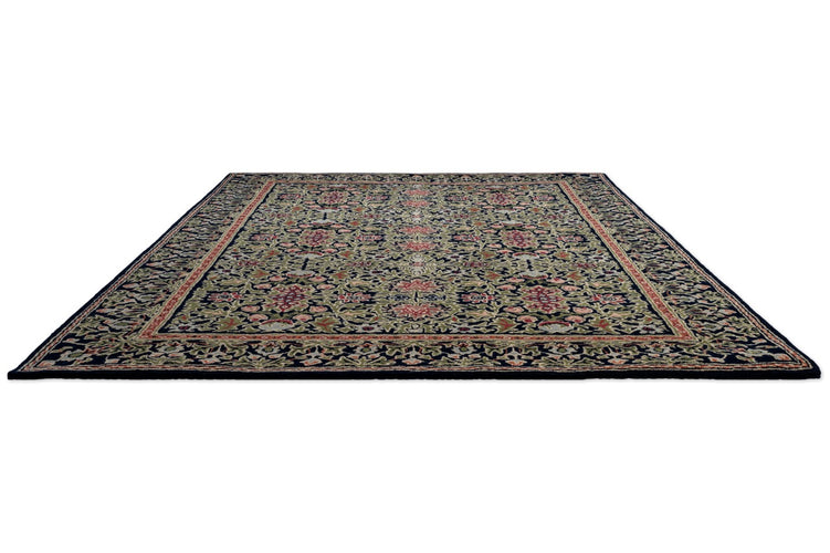 Morris & Co Wilton Weave Indigo rug in indigo, olive green and rose, perspective view