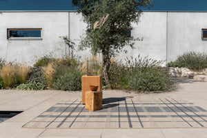 Exterior lounge featuring Zona Check Denim rug with modern seating on tiled patio