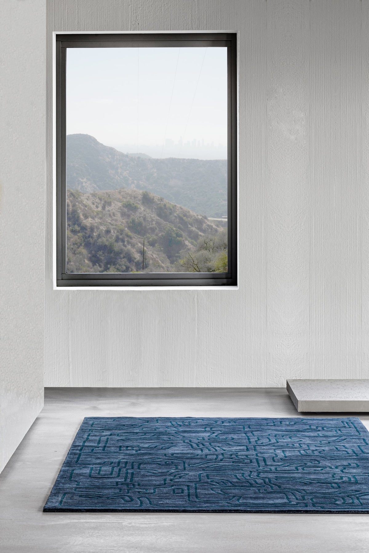 Massimo Structures Fragment 4 blue wool rug, shown in an interior