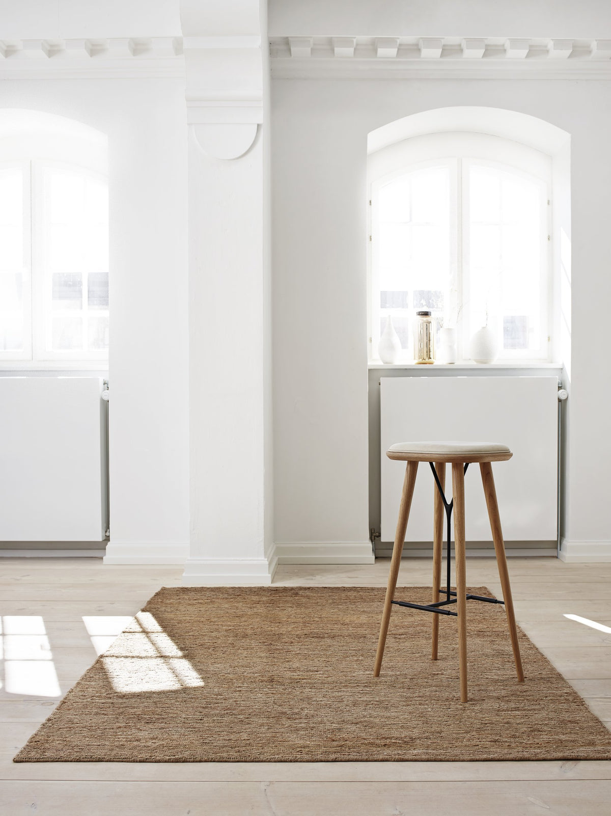Massimo Sumace Natural fringed jute rug, shown in an interior